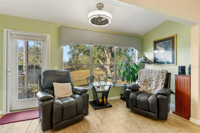 sitting room with lofted ceiling and light wood-type flooring