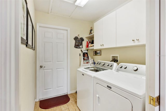 laundry room with separate washer and dryer, light hardwood / wood-style flooring, and cabinets