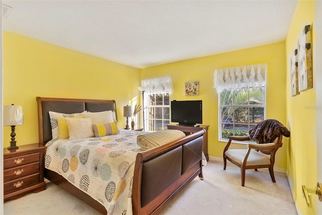 bedroom featuring light colored carpet