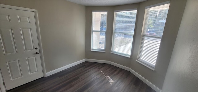 unfurnished room featuring dark hardwood / wood-style flooring