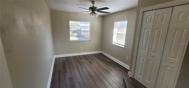 unfurnished bedroom featuring ceiling fan, dark hardwood / wood-style floors, a textured ceiling, and a closet