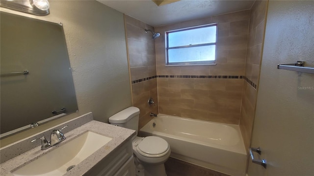 full bathroom featuring vanity, toilet, and tiled shower / bath combo