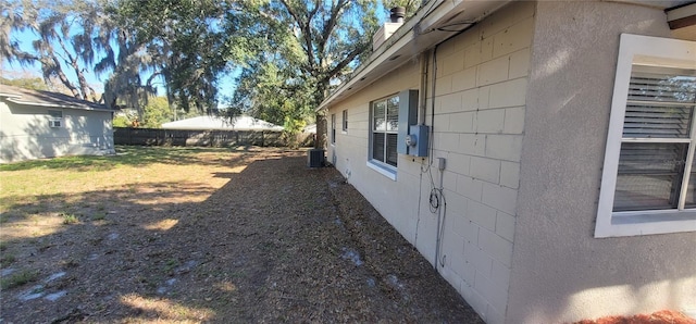 view of side of home with central AC