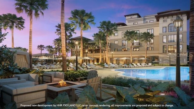 10601 Autumn Mist Ln Unit 302, Golden Oak, FL 32836 - pool at dusk featuring a patio area, an outdoor fire pit, and a community pool