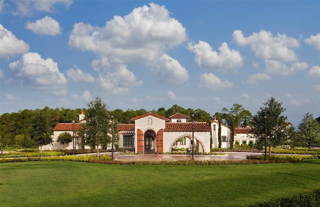 10601 Autumn Mist Ln Unit 302, Golden Oak, FL 32836 - view of front of property with a tile roof, a chimney, a front lawn, and stucco siding