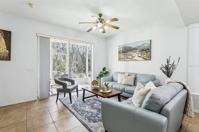 tiled living room with decorative columns and ceiling fan