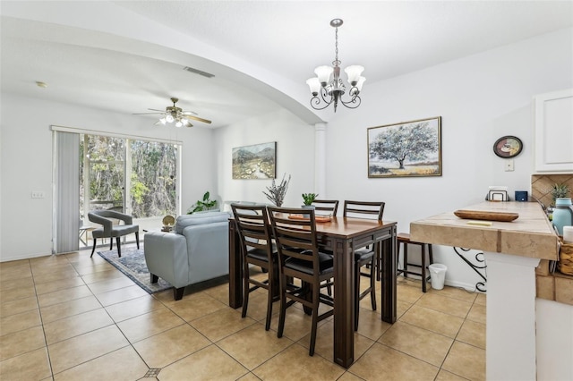 dining space featuring ceiling fan with notable chandelier and light tile patterned flooring