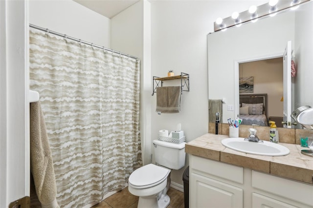 bathroom with vanity, toilet, and tile patterned flooring