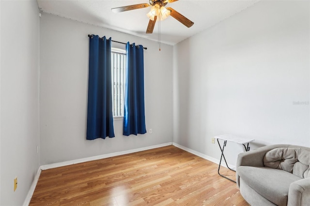 living area with ceiling fan and wood-type flooring