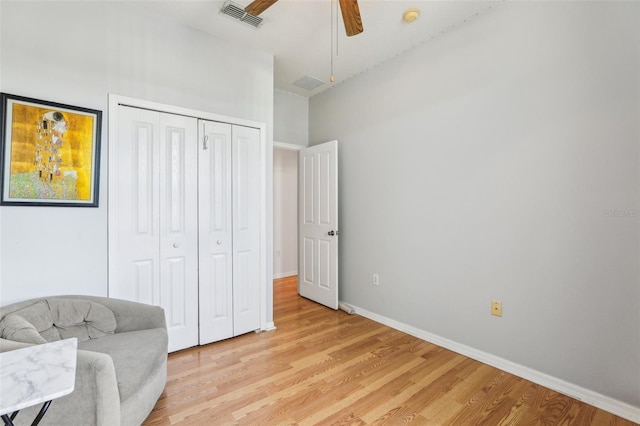 living area with light hardwood / wood-style floors and ceiling fan