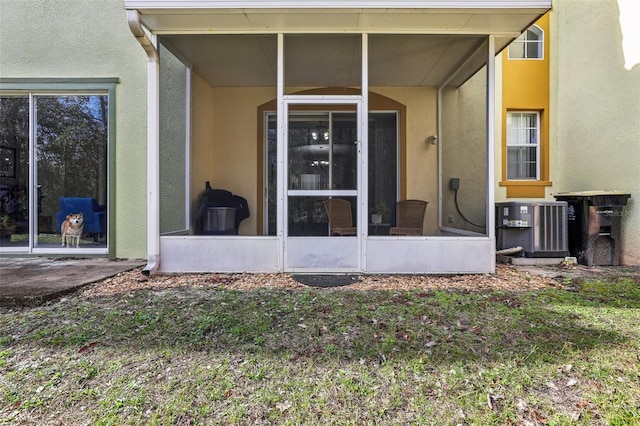 view of exterior entry with central AC unit