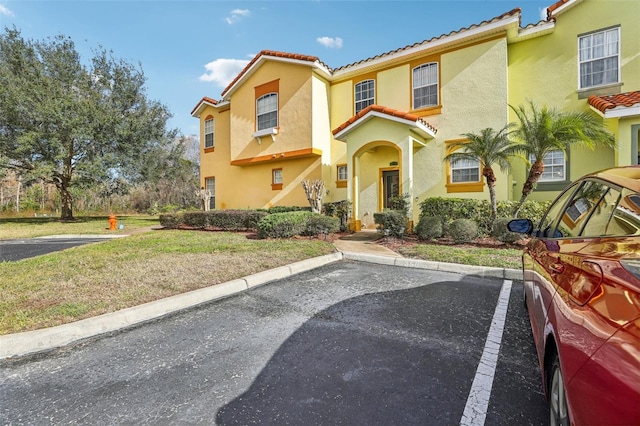 mediterranean / spanish-style home with a front yard