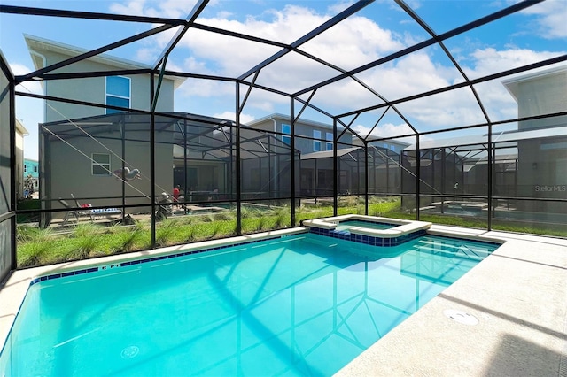 view of swimming pool with a lanai and an in ground hot tub