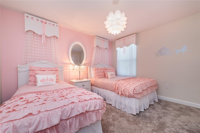 carpeted bedroom featuring an inviting chandelier