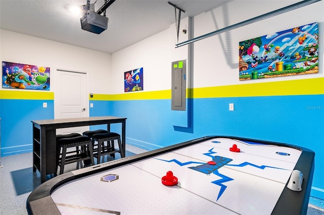 playroom with electric panel and a textured ceiling