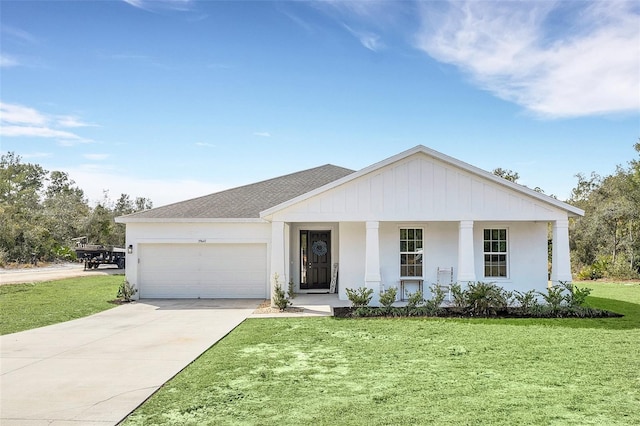 view of front of home featuring a garage, covered porch, and a front lawn