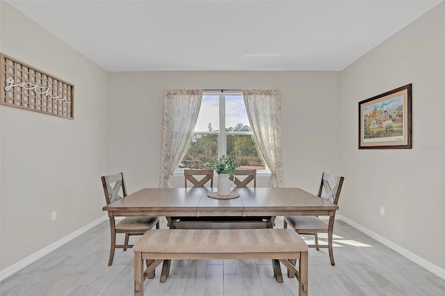 dining space featuring light wood-type flooring