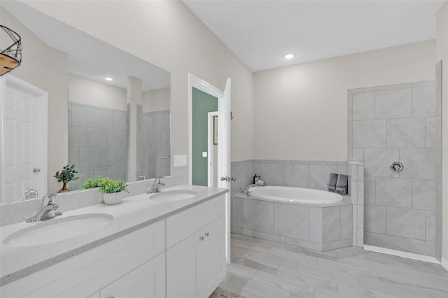 bathroom featuring vanity and separate shower and tub