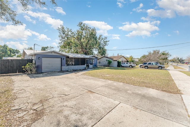 ranch-style house with a garage and a front lawn