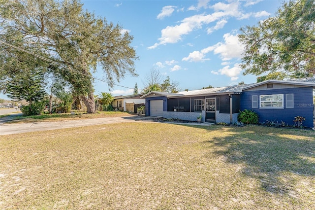 ranch-style home with a garage, a sunroom, and a front lawn