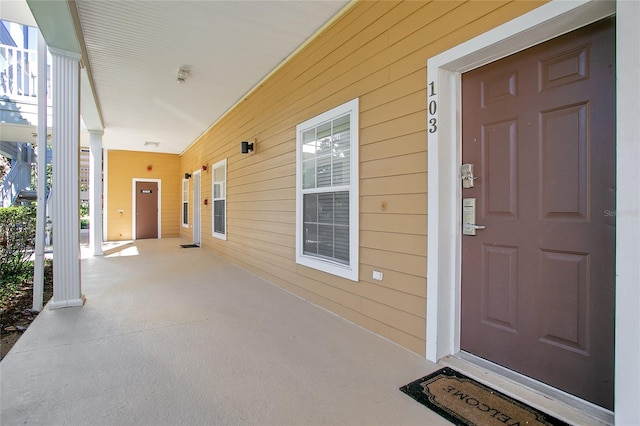 view of exterior entry with covered porch