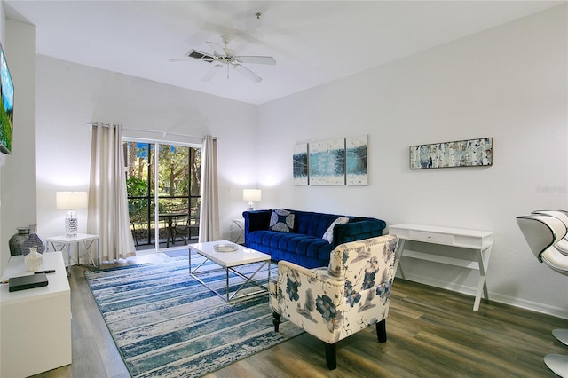 living room featuring dark hardwood / wood-style floors and ceiling fan