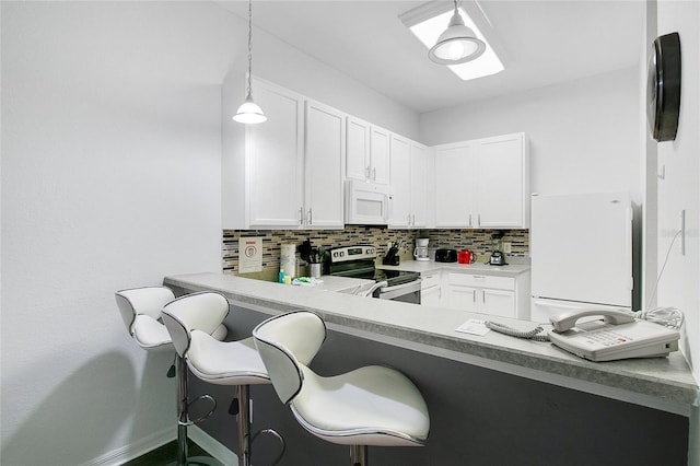 kitchen featuring white cabinetry, white appliances, a kitchen breakfast bar, and decorative light fixtures