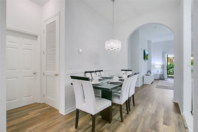 dining space with an inviting chandelier and hardwood / wood-style flooring