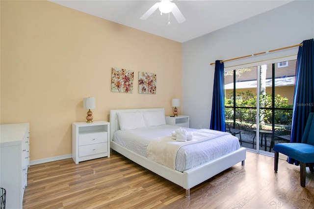 bedroom with access to exterior, hardwood / wood-style flooring, and ceiling fan