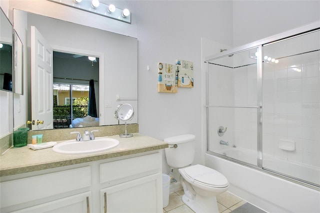 full bathroom featuring enclosed tub / shower combo, vanity, toilet, and tile patterned flooring