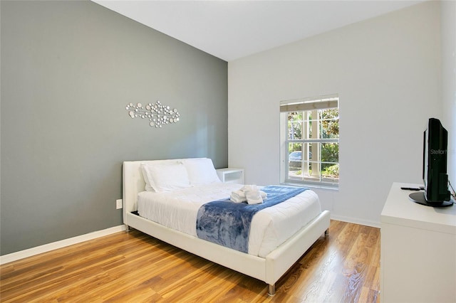 bedroom with hardwood / wood-style floors