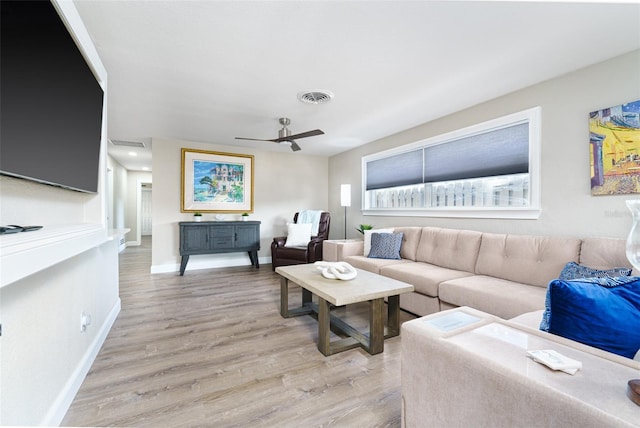 living room with ceiling fan and light hardwood / wood-style flooring