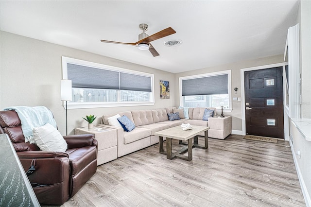 living room featuring ceiling fan and light wood-type flooring