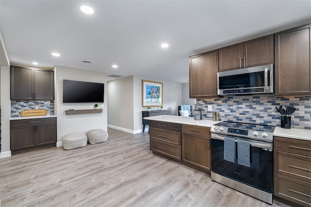 kitchen featuring stainless steel appliances and dark brown cabinets