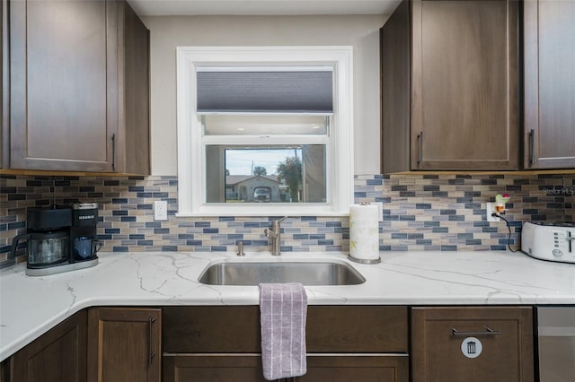 kitchen with dark brown cabinetry and sink