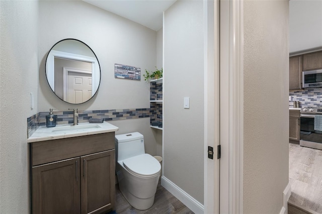 bathroom featuring vanity, toilet, hardwood / wood-style floors, and decorative backsplash