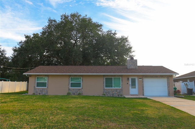 single story home with a garage and a front yard