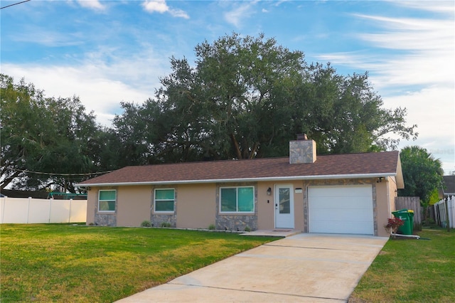 ranch-style house featuring a garage and a front yard