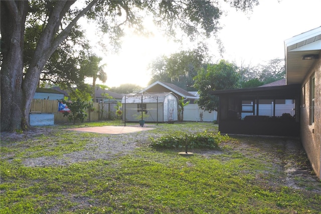 view of yard featuring a shed and a patio