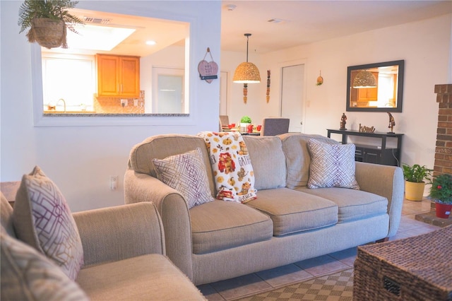 living room with tile patterned flooring and sink