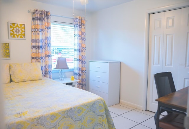 tiled bedroom with a closet