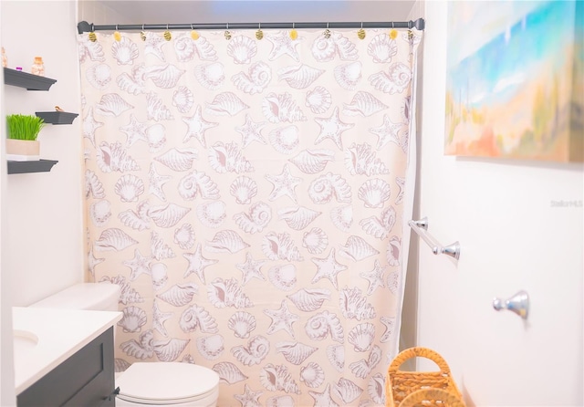 bathroom featuring vanity, walk in shower, and toilet