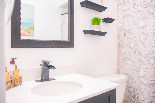 bathroom featuring vanity, toilet, and a shower with shower curtain