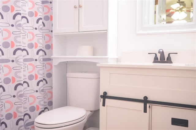 bathroom featuring vanity and toilet