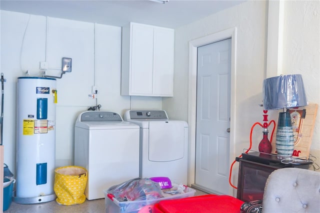 laundry room featuring cabinets, washing machine and dryer, and water heater