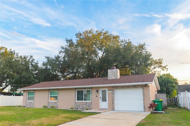 ranch-style home featuring a garage and a lawn