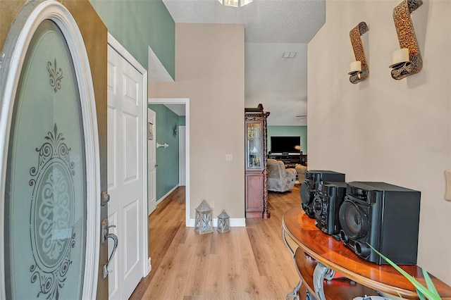 entrance foyer featuring light hardwood / wood-style flooring and a textured ceiling