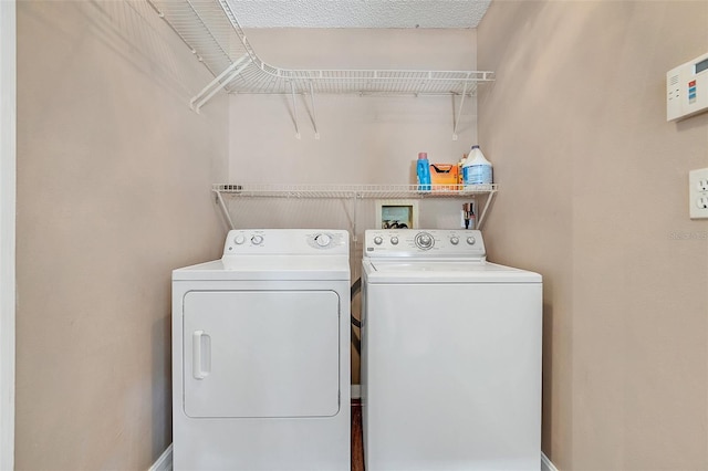 clothes washing area featuring separate washer and dryer