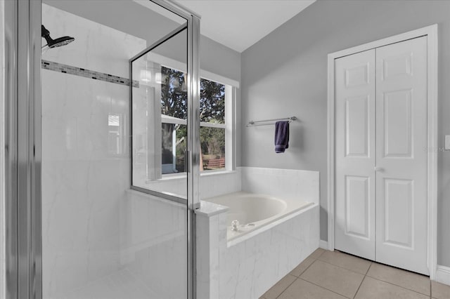 bathroom with independent shower and bath and tile patterned floors