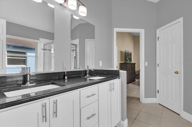 bathroom featuring a shower with door, vanity, and tile patterned floors